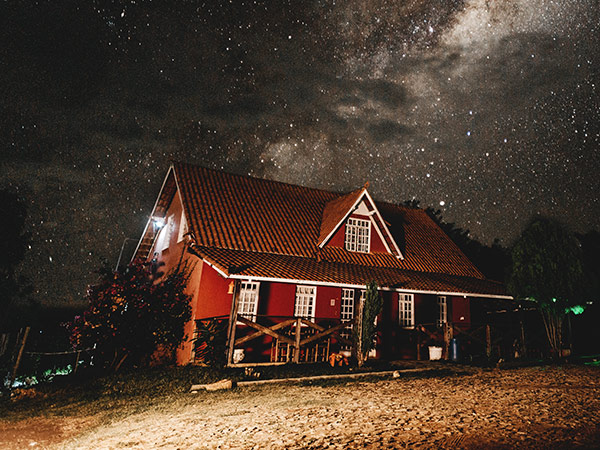 Una casa en el campo bajo un cielo estrellado